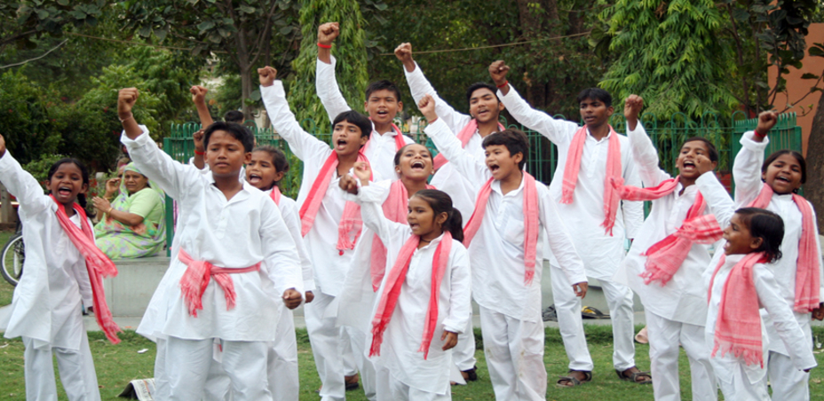 A group of childern performing in the park.