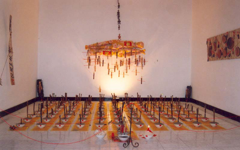 Artwork hanging from the ceiling and on the floor.